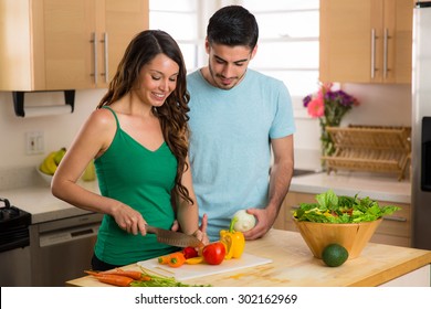 Beautiful Woman And Handsome Man Chopping Vegetables Organic Salad Paleo Vegan Vegetarian Diet