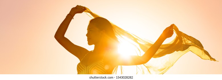 Beautiful Woman Happy Free In Sunset Glow Waving Scarf In The Wind Dancing In Sun Panoramic Banner. Silhouette Feminine Lady Freedom For Wellness And Healthy Living.