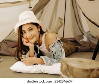 Beautiful Woman Happy Lying On Floor In Camping Tent Looking At Camera Smiling, Portrait. Young Female Tourist Enjoys Outdoor Adventure On Holiday Recreation. Journey, Leisure Activity On Vacation.