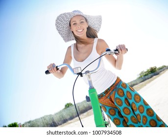 Beautiful Woman With Hat Riding Bike In Miami Beach