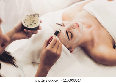 Beautiful woman having a facial cosmetic scrub treatment from professional dermatologist at wellness spa. Anti-aging, facial skin care and luxury lifestyle concept. - Shutterstock ID 1170933067
