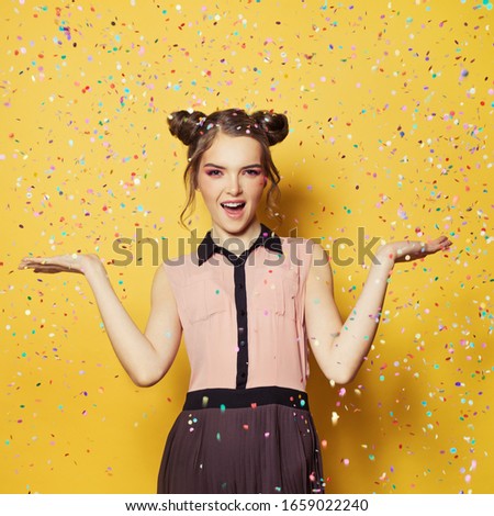 Beautiful woman having fun, colorful confetti holiday party