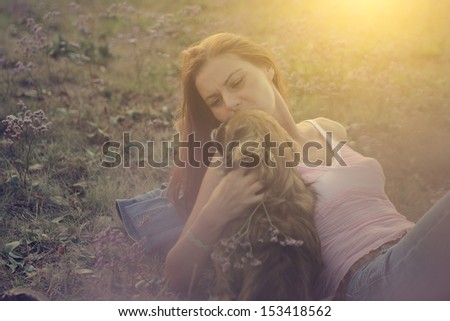Beautiful woman with her dog in the nature