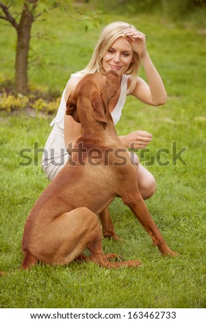 Similar – Pretty blond woman with her two dogs