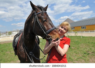 Beautiful woman with her favorite horse on the ranch.