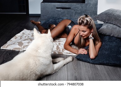 Beautiful woman and her pet dog companion in the apartment - Shutterstock ID 794807038