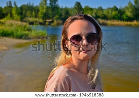 Beautiful woman in her prime by the lake.