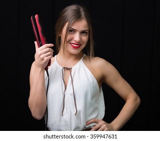 Beautiful Woman Holding A Flat Hair Iron