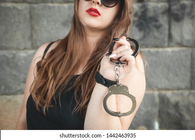 Beautiful Woman Holding Handcuffs.