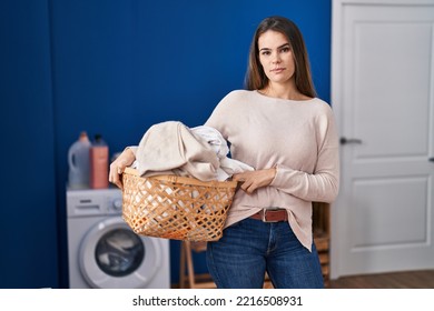 Beautiful Woman Holding Laundry Basket Thinking Attitude And Sober Expression Looking Self Confident 