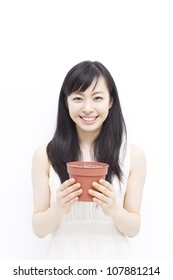 Beautiful Woman Holding Plant Pot