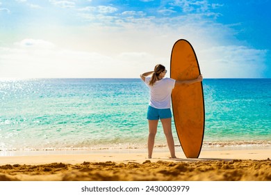 Beautiful woman holding surfboard standing on sunny beach Santa Maria, Sal island , Cape Verde  - Powered by Shutterstock