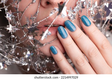 Beautiful Woman With Holiday Manicure - Blue Glitter Nails With Silver Twisted Wire With Stars. Closeup View. Nail Care Concept