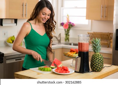 Beautiful Woman Home In Kitchen Making A Smoothie With Blender Fresh Fruit Ingredients Organic