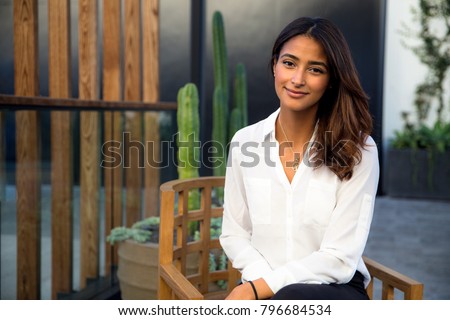 Beautiful woman at home sitting casual on her patio relaxing and enjoying leisure time alone Stock photo © 