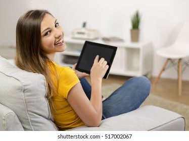 Beautiful Woman At Home Working With A Tablet