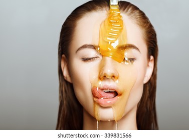 Beautiful woman with honey on her face. Healthy perfect skin. Honey treatment. 