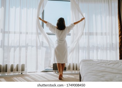 Beautiful Woman In A Hotel Room In A White Bathrobe