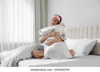 Beautiful Woman Hugging Pillow On Comfortable Bed With Silky Linens