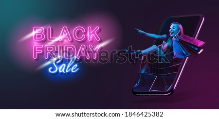 Beautiful woman inviting for shopping right from device screen, black friday, sales concept. Flyer. Cyber monday and online purchases, negative space for ad. Finance and money. Dark neon background.