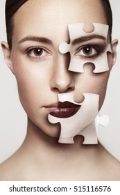 Beautiful Woman With Jigsaw Pieces On Face