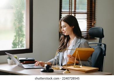 Beautiful woman lawyer working and gavel, tablet, laptop in front, Advice justice and law concept. - Shutterstock ID 2240728545