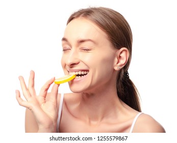 Beautiful Woman With Lemon Beauty Fashion Skin Freshness Face, Eats Sour Lemon On A White Background. Isolation