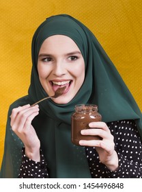 Beautiful Woman Licking Chocolate Holding Jar And Spoon