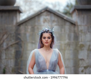 a beautiful woman like a fairy or nymph walking in the park. fairy tale image art photo. nymph of castle