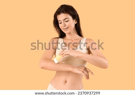 Beautiful woman with liposoluble wax cartridge on beige background
