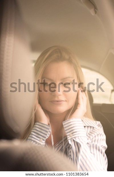 Beautiful woman\
listening to the music in\
car.