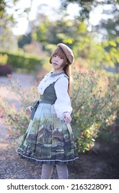 A Beautiful Woman In Lolita Dress In Garden Background Japanese Street Fashion Portrait