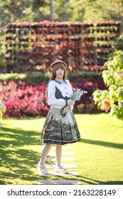 A Beautiful Woman In Lolita Dress In Garden Background Japanese Street Fashion Portrait