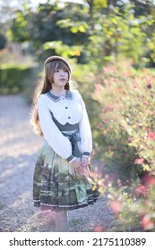 A Beautiful Woman In Lolita Dress In Garden Background Japanese Street Fashion Portrait