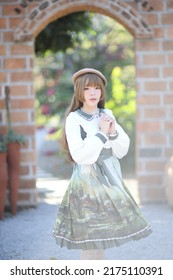 A Beautiful Woman In Lolita Dress In Garden Background Japanese Street Fashion Portrait