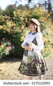 A Beautiful Woman In Lolita Dress In Garden Background Japanese Street Fashion Portrait