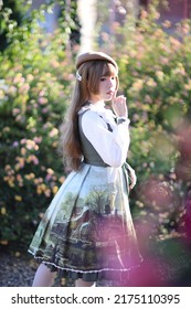 A Beautiful Woman In Lolita Dress In Garden Background Japanese Street Fashion Portrait