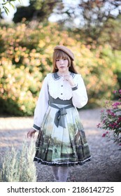 A Beautiful Woman In Lolita Dress In Garden Background Japanese Street Fashion Portrait