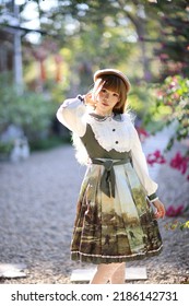 A Beautiful Woman In Lolita Dress In Garden Background Japanese Street Fashion Portrait