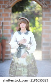 A Beautiful Woman In Lolita Dress In Garden Background Japanese Street Fashion Portrait