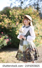 A Beautiful Woman In Lolita Dress In Garden Background Japanese Street Fashion Portrait