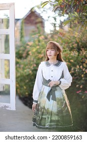 A Beautiful Woman In Lolita Dress In Garden Background Japanese Street Fashion Portrait