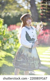 A Beautiful Woman In Lolita Dress In Garden Background Japanese Street Fashion Portrait