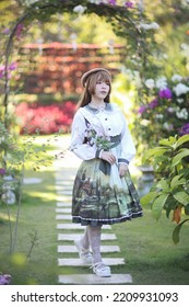 A Beautiful Woman In Lolita Dress In Garden Background Japanese Street Fashion Portrait