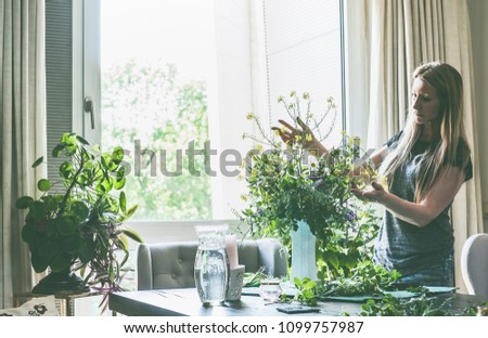 Similar – Woman makes wildflower bouquet in vase on the table