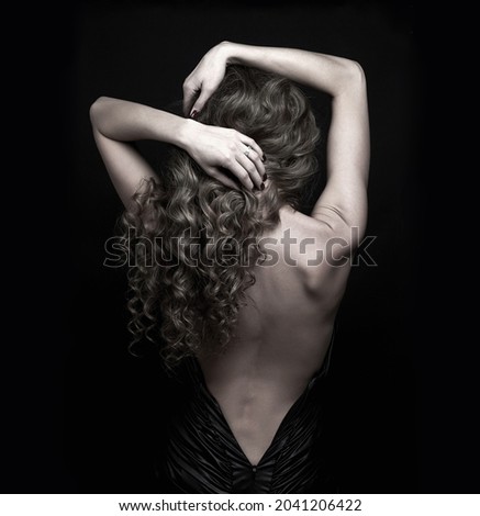 Similar – Young woman in black lingerie in chiaroscuro lighting