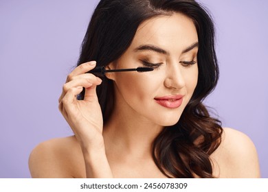 A beautiful woman with long dark hair applies mascara to her lashes. - Powered by Shutterstock