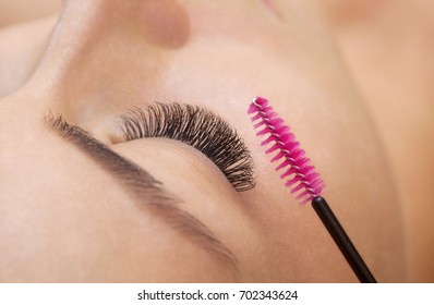 Beautiful Woman With Long Eyelashes In A Beauty Salon. Eyelash Extension Procedure. Lashes Close Up