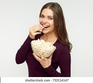 Beautiful woman with long hair eating pop corn. Isolated studio portrait.