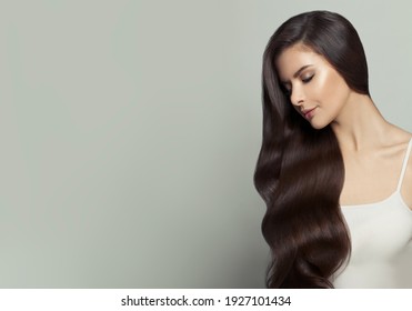 Beautiful Woman With Long Healthy Hair On White Background. Haircare And Facial Treatment Concept